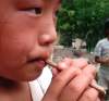 Child blowing dongdongkui flute